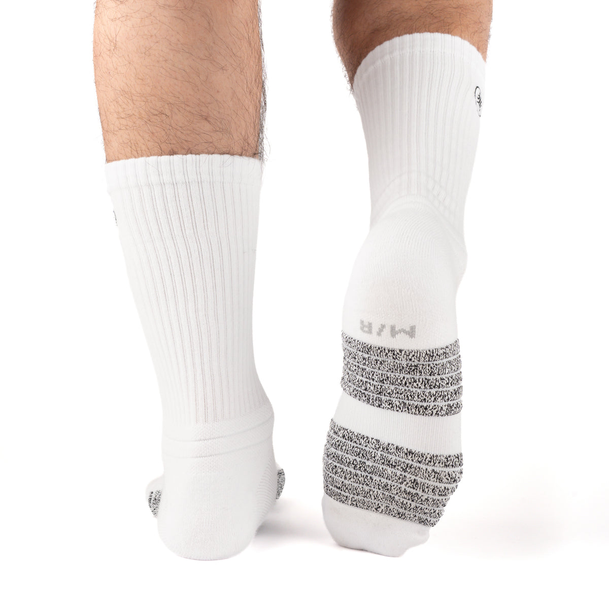White Performance Crew Socks worn on model, rear view showing high-friction footbed